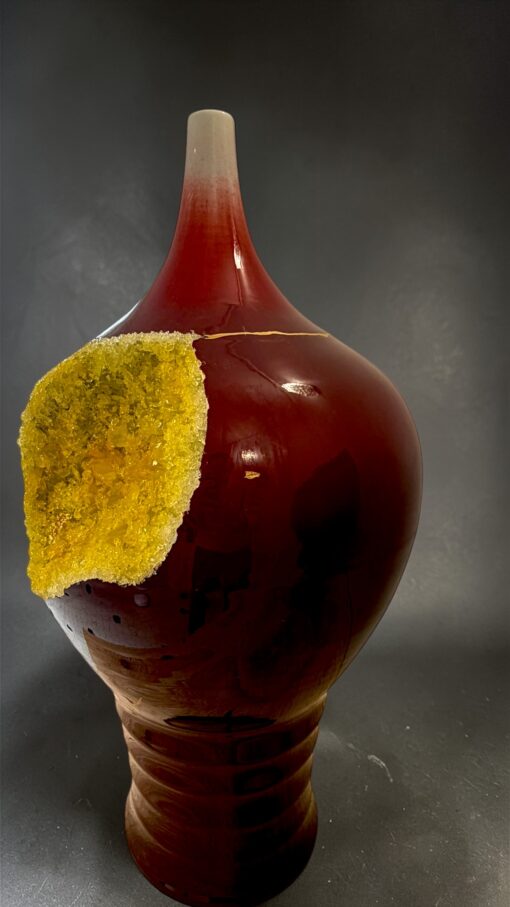 IMG_0789 | Kintsugi by Myriam GREFF Glossy amber ceramic vase with a yellow, crusty chunk attached to its side.