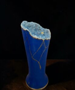 Blue ceramic vase with a jagged blue geode top rim and gold vein cracks running down the sides.